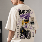 Man wearing Luri Bad Day Who Cares graphic oversized t-shirt — cream unisex attitude tee with graffiti streetwear duck, "Bad Day? Who Cares!" bold text and purple smiley sticker graphics, back view