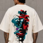Man wearing Luri Crowned Face graphic oversized t-shirt — cream unisex street art tee with bold abstract crowned face print in teal and red on premium cotton, back view