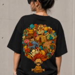 Woman wearing Luri India Mind graphic oversized t-shirt — black unisex tee with colourful Indian heritage doodle art, meditating turban figure with elephant, lotus and peacock motifs, back view
