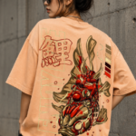 Woman wearing Luri Koi Rising graphic oversized t-shirt in peach — unisex streetwear tee with Japanese armoured Koi fish illustration and kanji virtue words on Supima Cotton, back view
