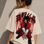 Woman wearing Luri Red Striker anime graphic oversized t-shirt — cream unisex streetwear tee with dark anime hooded figure, red jacket, explosive energy lines and Japanese kanji back print, back view \