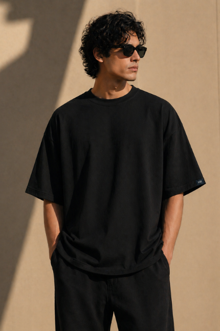 Man wearing Luri Signature Oversized Tee in black — premium unisex 260 GSM Mercerized Supima Cotton t-shirt, front view, clean minimal boxy oversized fit