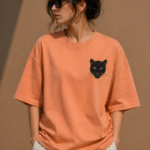 Woman wearing Luri Silent Panther oversized t-shirt in terracotta — front view showing black panther face chest print on premium Supima Cotton, relaxed boxy oversized fit