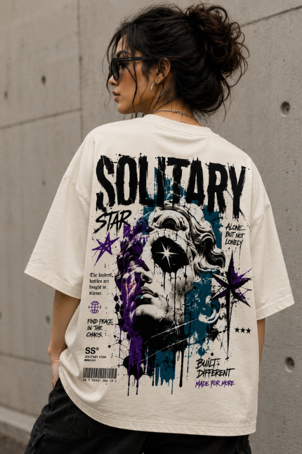 Woman wearing Luri Solitary Star graphic oversized t-shirt — cream unisex streetwear tee with grunge classical marble statue print, star motifs and bold typography in black, purple and teal, back view